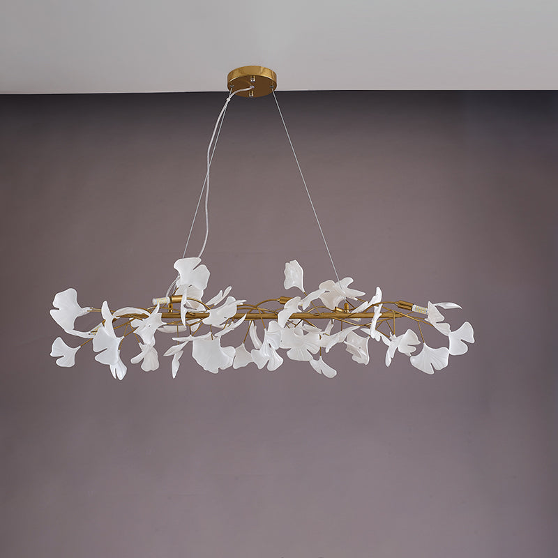 Gold 59-inch ceramic ginkgo leaf linear chandelier shown unlit.