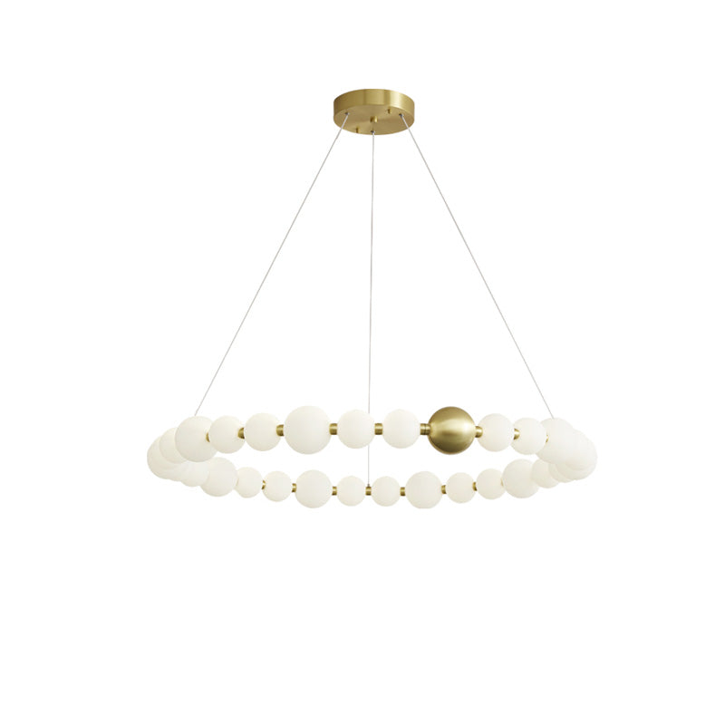 Large 41-inch pearl-ring chandelier stretches its luminous necklace form across the ceiling, creating an elegant focal point for a spacious interior.