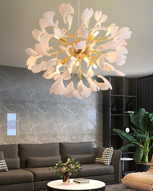 A contemporary living space with a leather sofa and a marble coffee table; a single white gingko globe chandelier hangs overhead.
