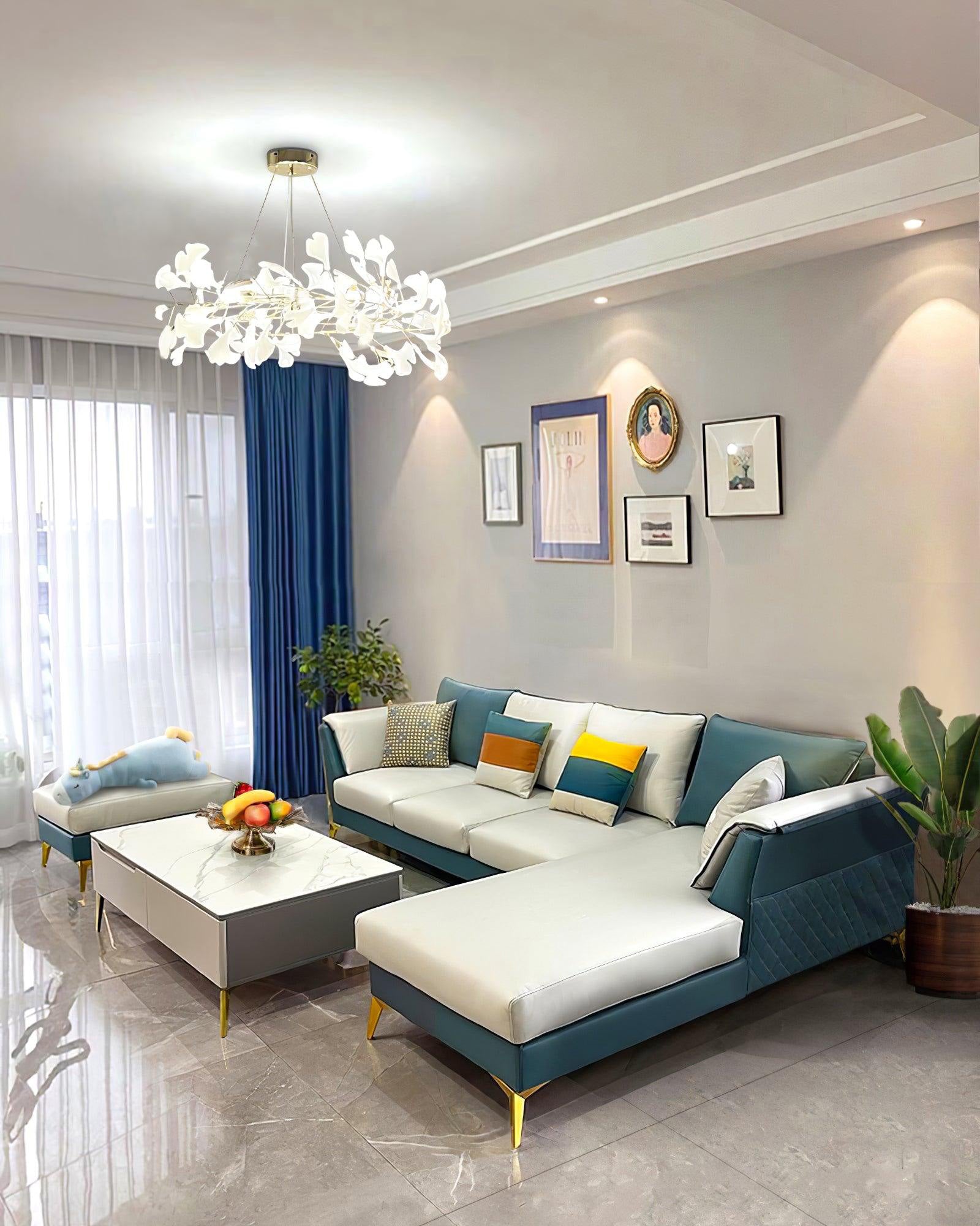 White ceramic leaf chandelier in a living room with a blue-and-white sectional sofa.