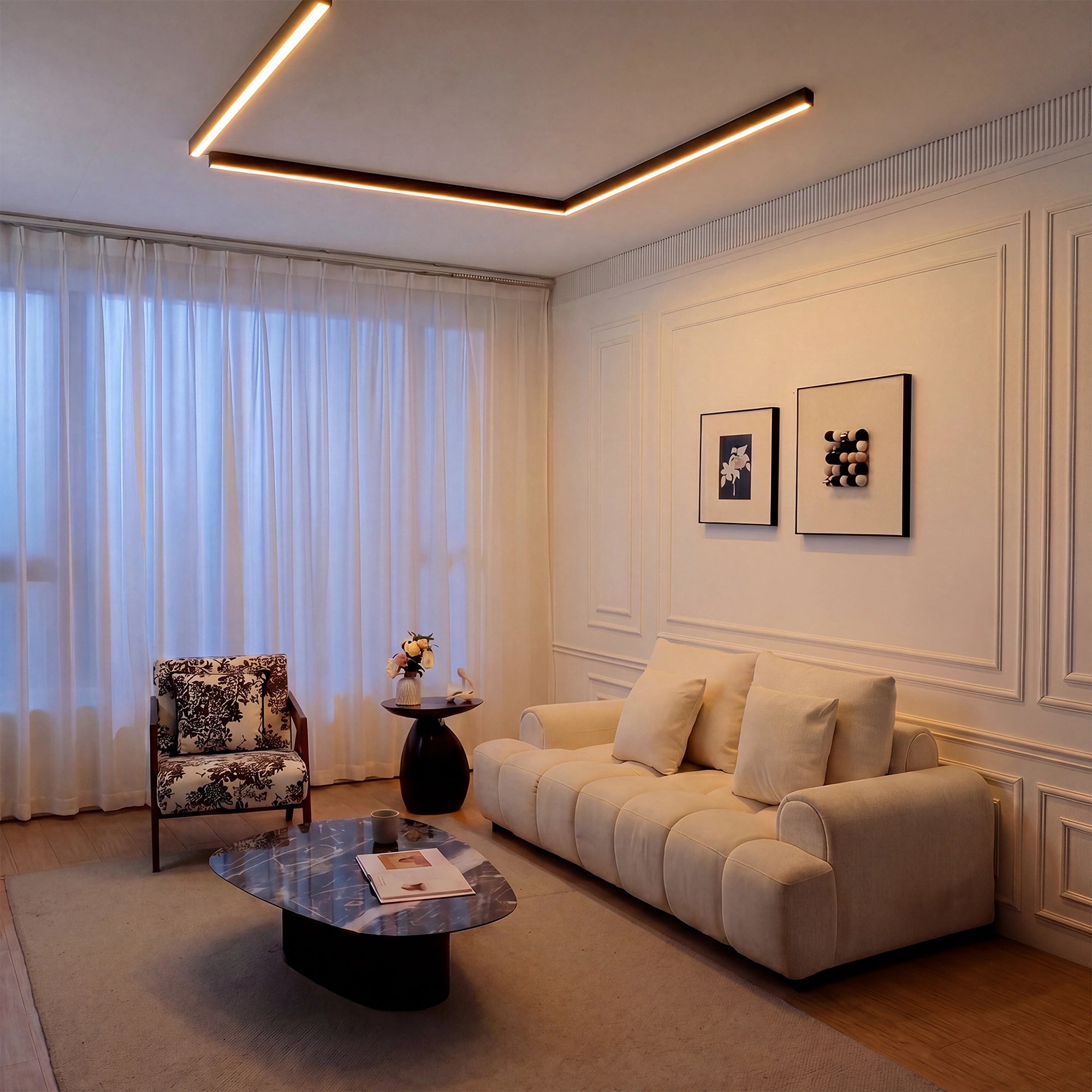 A long linear Modern Ceiling Light in a lounge with soft perimeter glow, creating a warm and refined evening atmosphere.