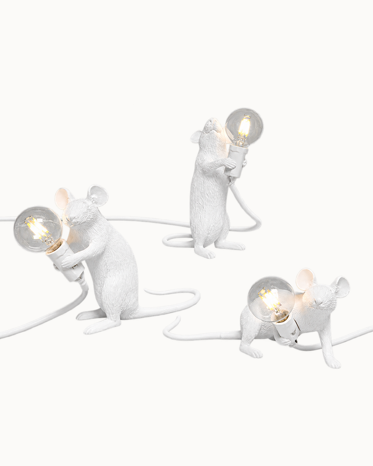 Three white mouse lamps in sitting, standing, and crouching poses, each holding a glowing exposed bulb against a clean white background.