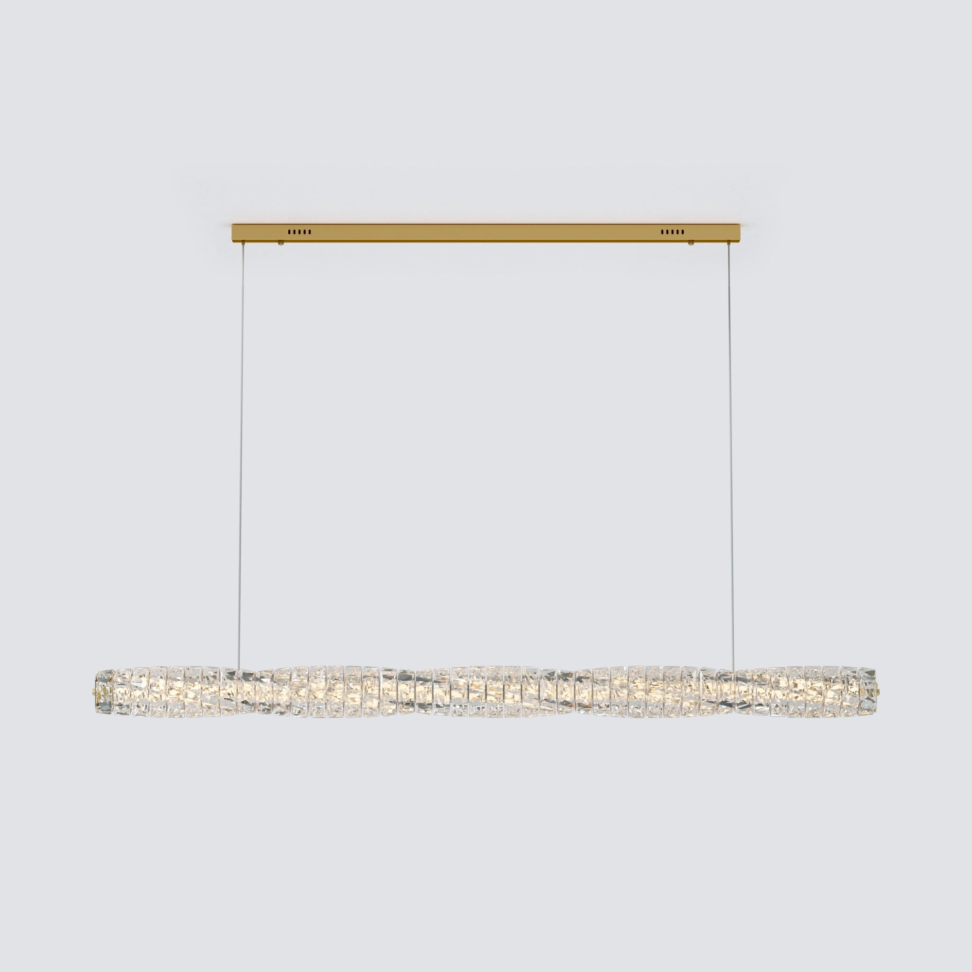 Wide gold oblong chandelier with crystals shown against a light gray background, with a gently undulating crystal bar.