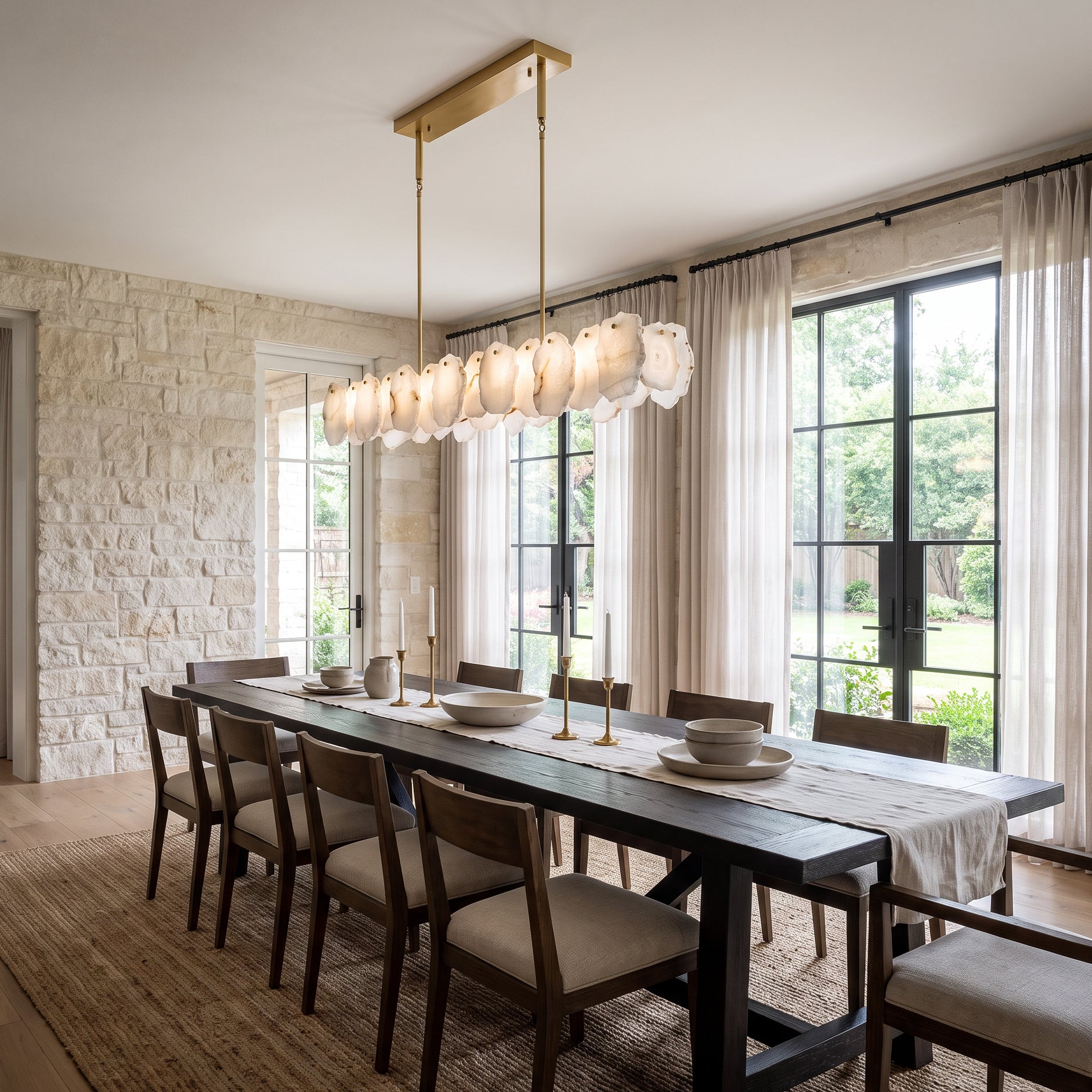 Rectangular alabaster chandelier with natural stone shades creating a sophisticated focal point above a modern dining table