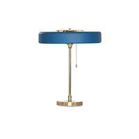 Blue pull chain table lamp with a wide circular metal shade, slim gold-tone frame and hanging chain on white.