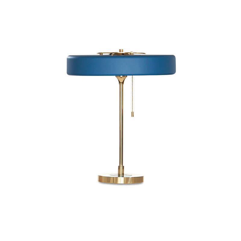 Blue pull chain table lamp with a wide circular metal shade, slim gold-tone frame and hanging chain on white.