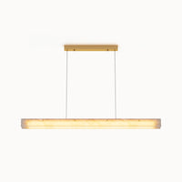 Front view of a glowing alabaster linear chandelier with a gold rectangular canopy and slim suspension cables on a white background.
