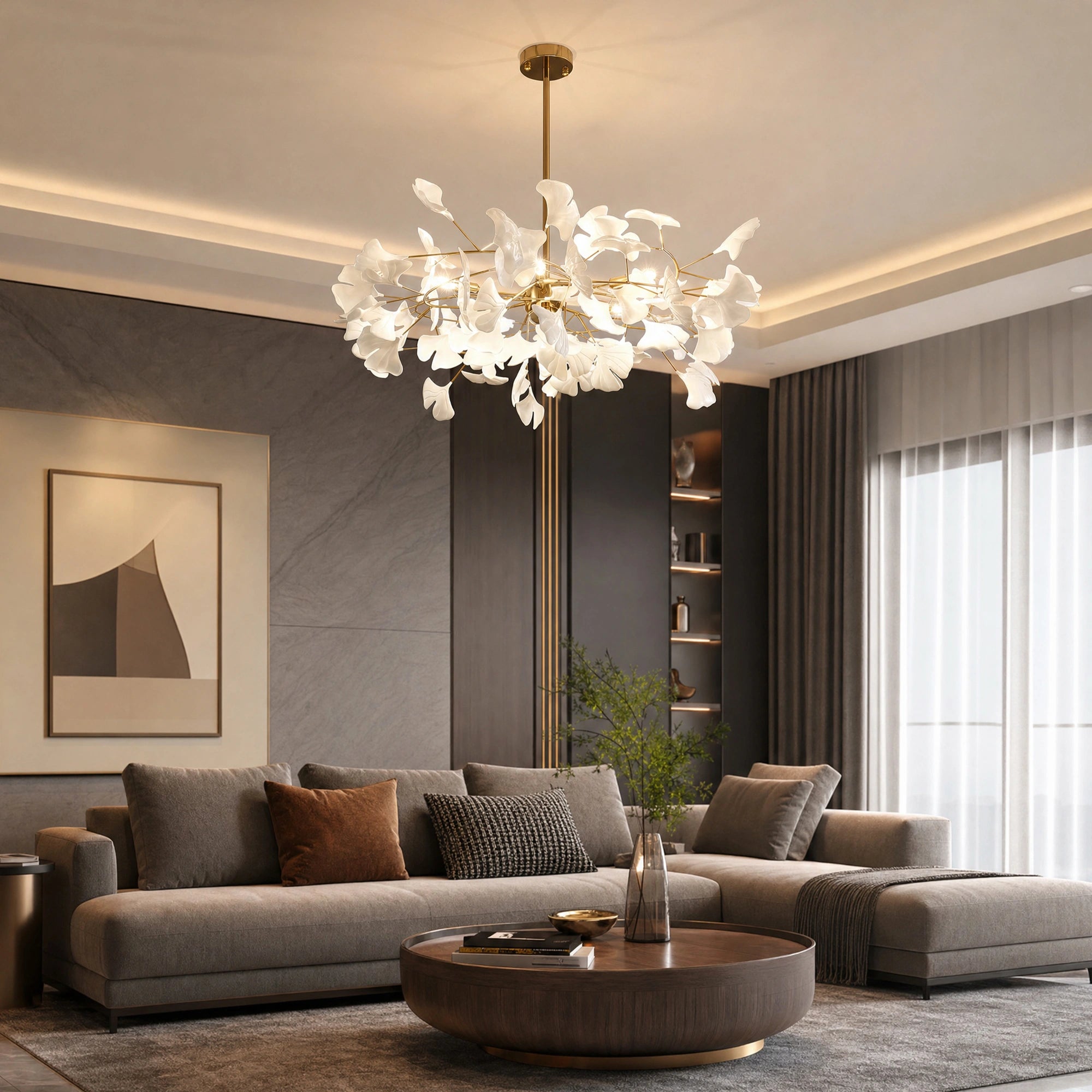 Illuminated modern ginkgo chandelier creating a warm botanical focal point above a curved sofa