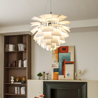 White Scandinavian pendant light with layered pinecone shades, glowing softly in a modern home interior.