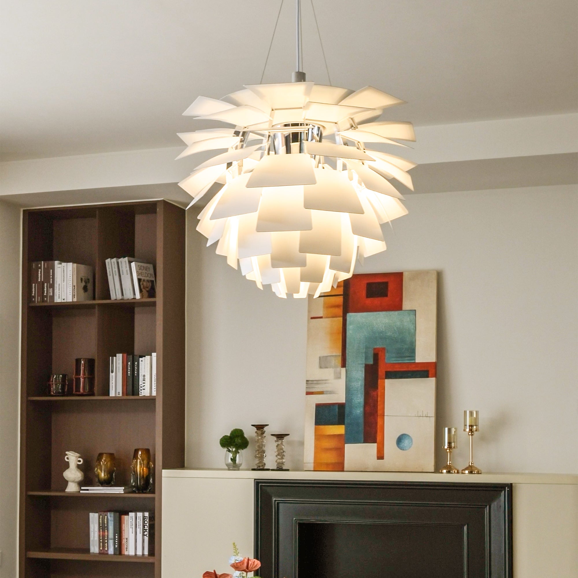 White Scandinavian pendant light with layered pinecone shades, glowing softly in a modern home interior.