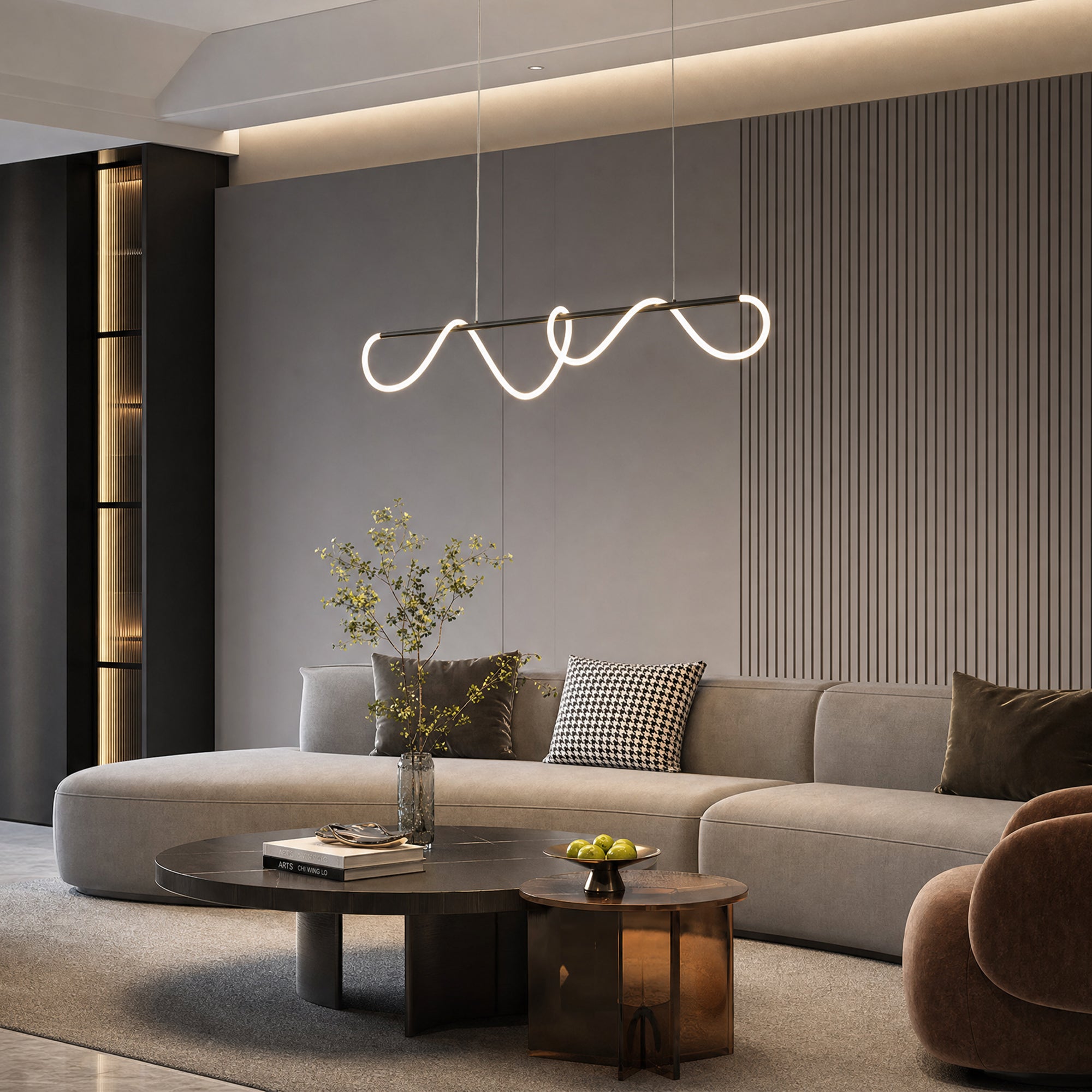 Matte-black linear chandelier with illuminated looping silicone suspended above a curved sofa in a dark contemporary living room.