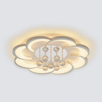 Compact Ø20.5-inch flower flush mount light with layered petals and central crystal drops, illuminated against a light gray background.