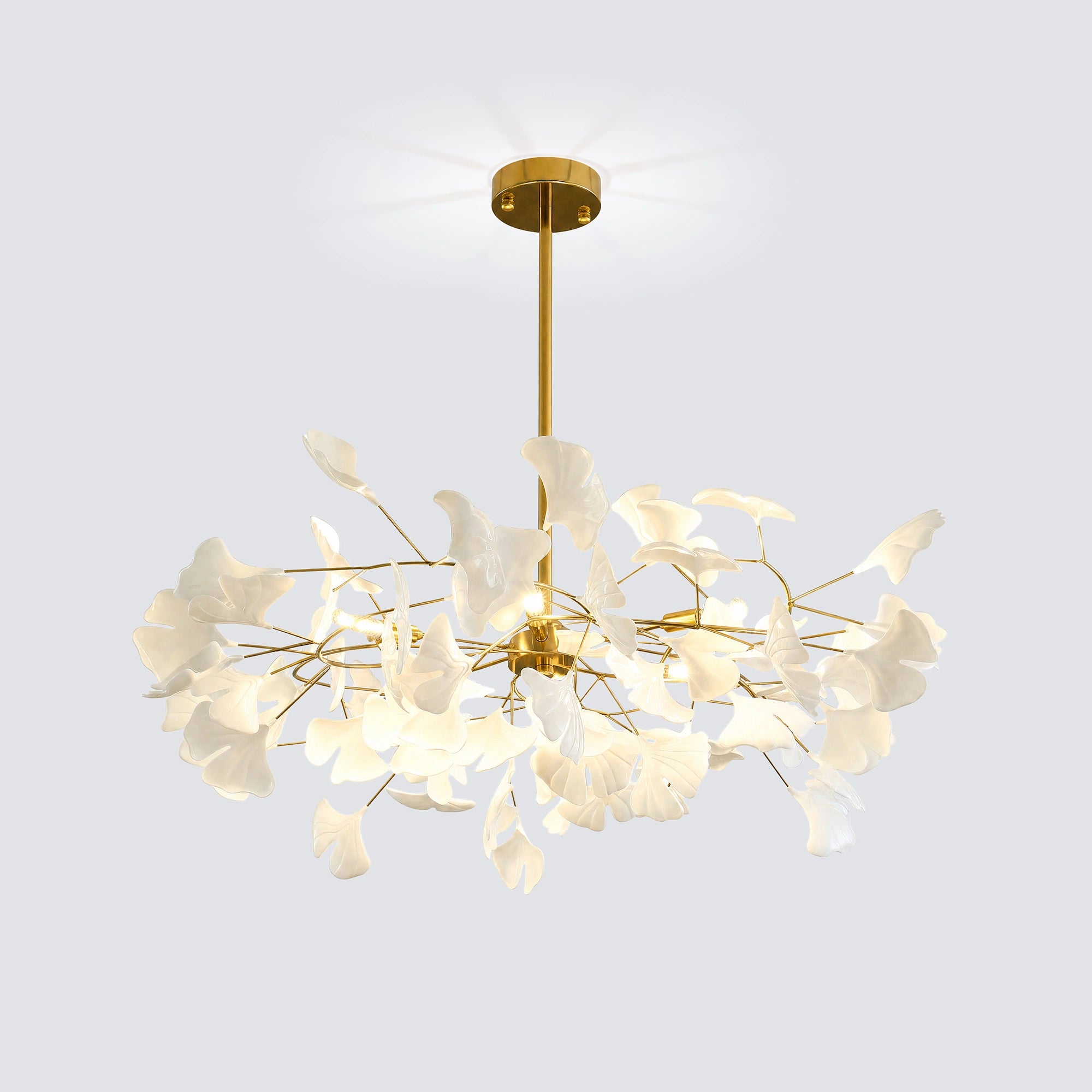 Illuminated white and gold round ginkgo chandelier shown against a light gray background