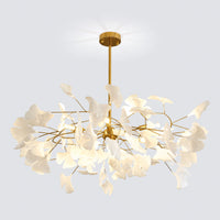 Sculptural white ginkgo chandelier with a gold canopy and dense circular leaf arrangement