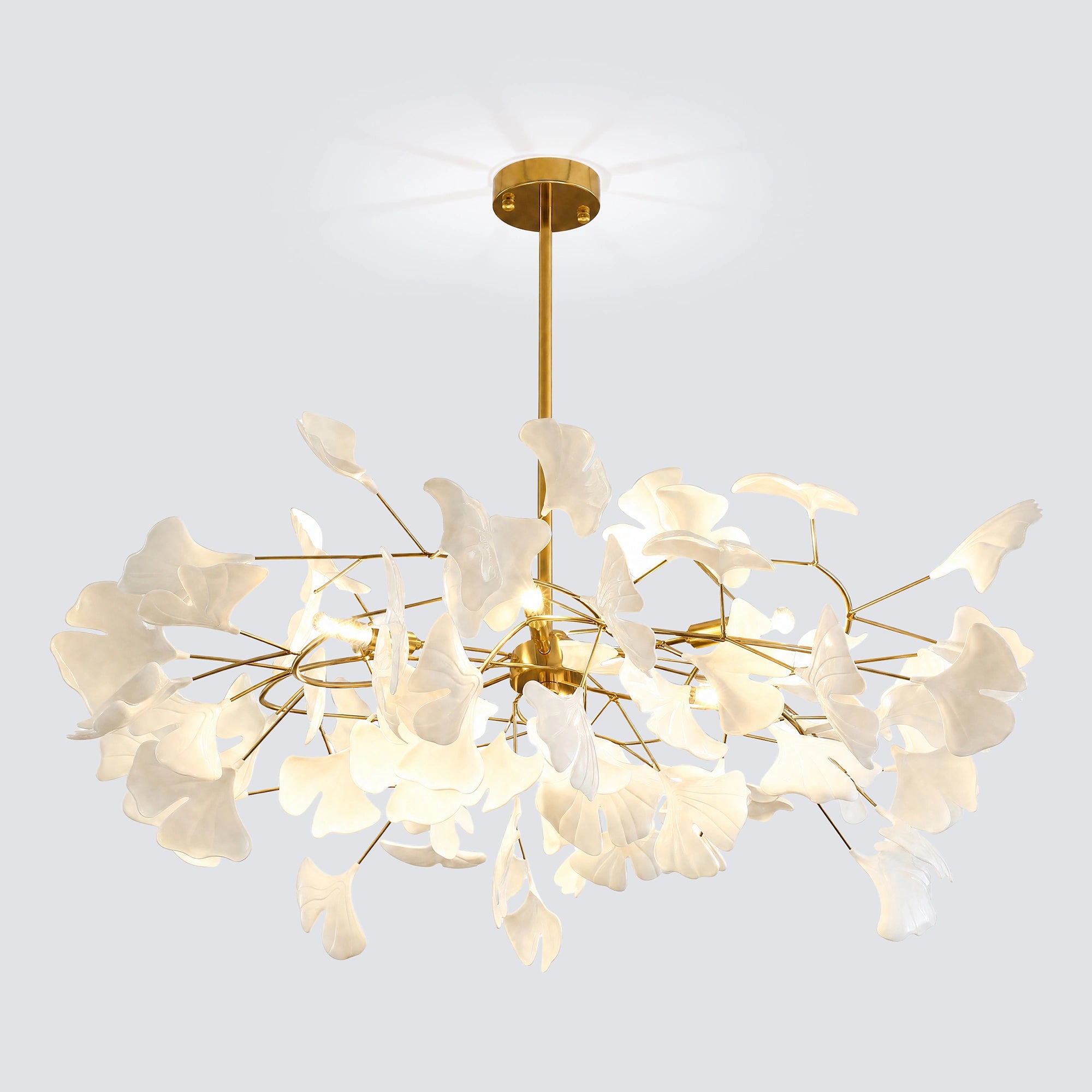 Sculptural white ginkgo chandelier with a gold canopy and dense circular leaf arrangement