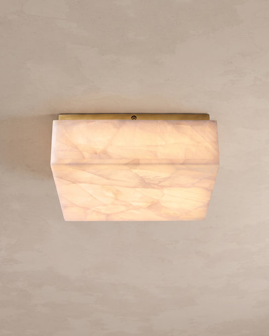 WOMO WM1115 illuminated square alabaster ceiling light showing veined panels and a slim gold-toned mounting edge.