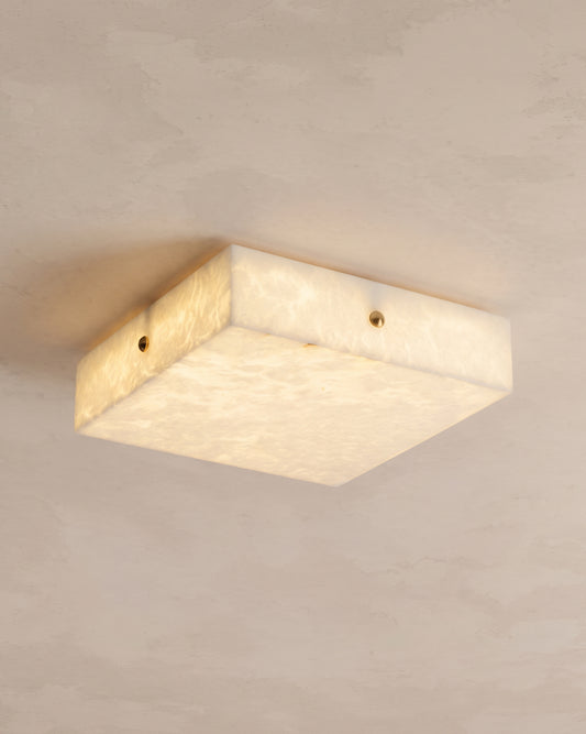 Low-angle view of the WOMO WM1136 square alabaster ceiling light with softly glowing panels and small side fasteners.
