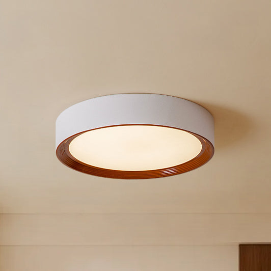 White flush mount ceiling light fixture with a walnut-finish inner ring and warm acrylic diffuser