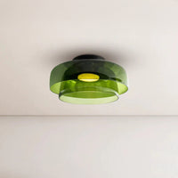 Green acrylic flush mount drum light fixture with two overlapping round shades and a warm light at the center.