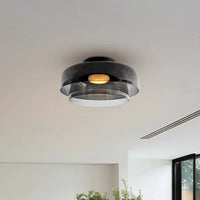 Smoked two-tier modern ceiling light fixture with concentric acrylic shades in a bright contemporary interior.