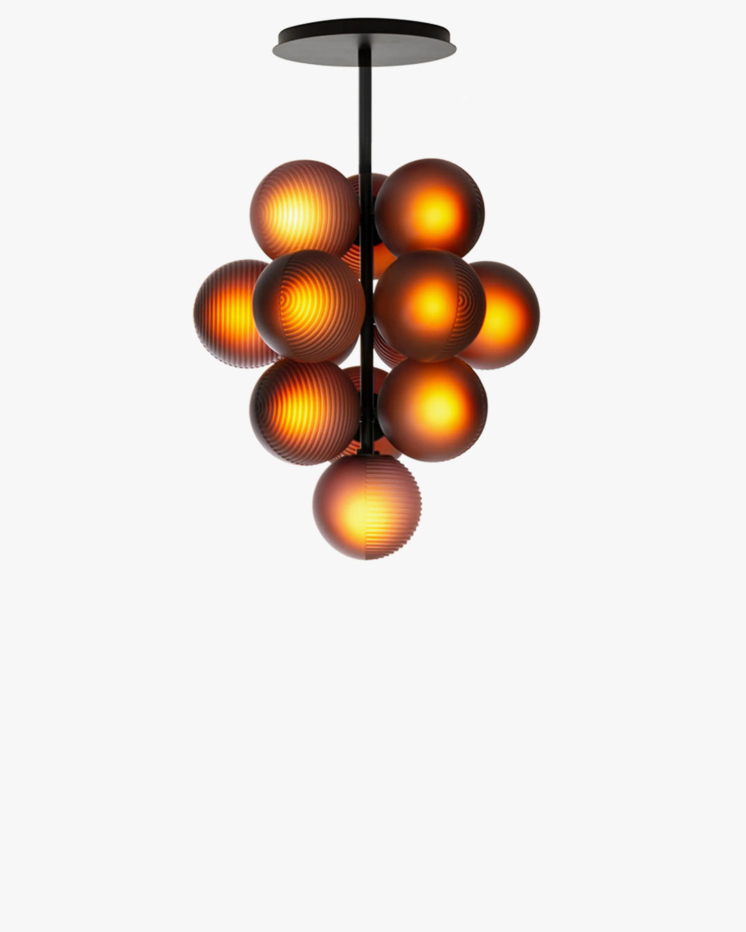 Front view of the illuminated grape chandelier with warm light glowing through purple glass globes.