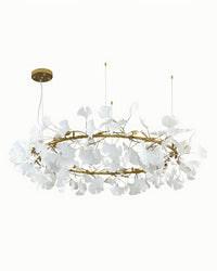 Gold round ceramic ginkgo leaf chandelier with layered white leaves on a white background.
