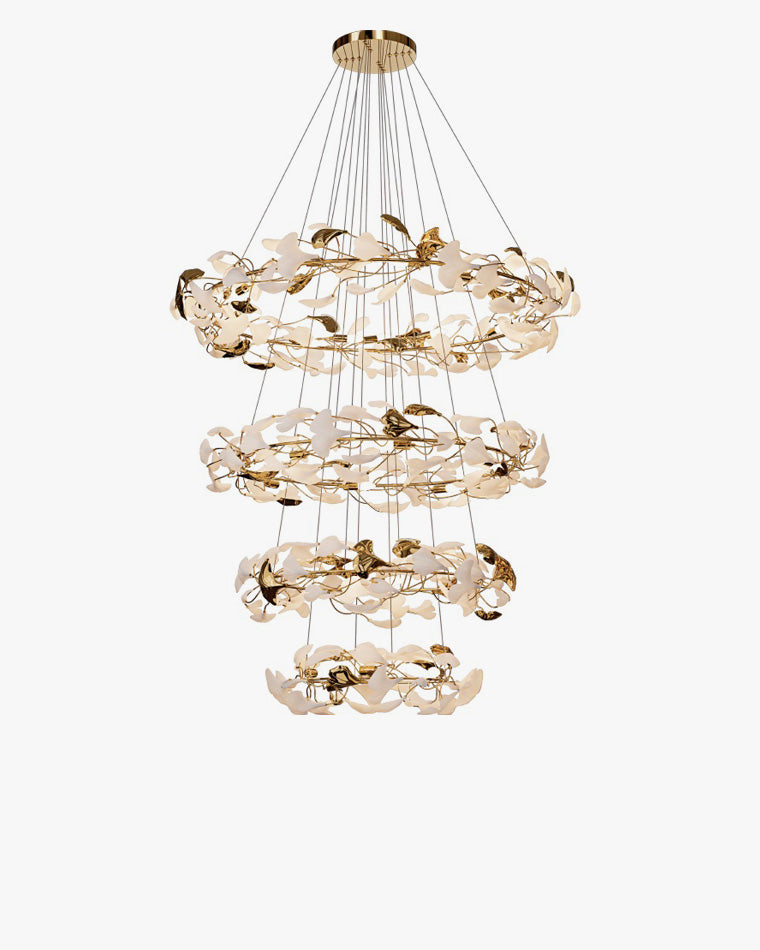 Four-tier gingko chandelier with circular rings of white leaf shades and reflective gold accents.