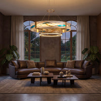 Round brass chandelier with textured glass and warm integrated LED glow above a modern living room seating area.
