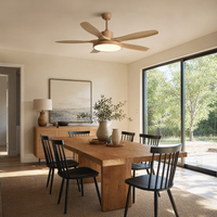 Wood blade ceiling fan with light above a dining area, showing natural texture, airflow, and soft integrated lighting.
