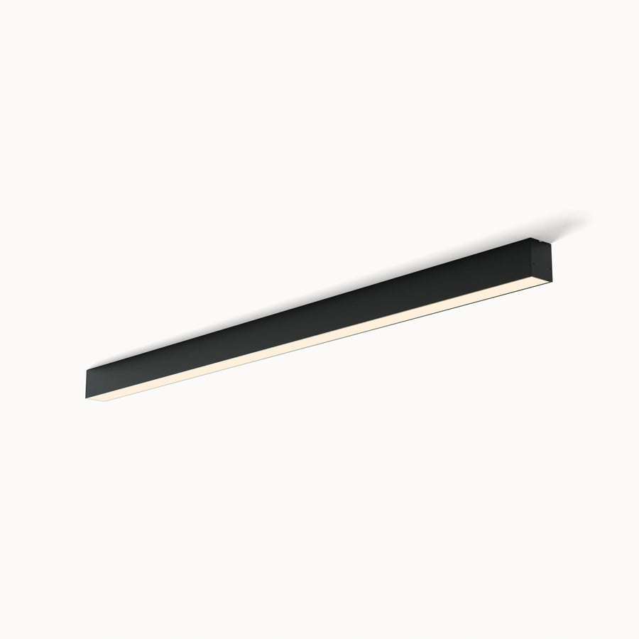A slim black long linear Flush Mount Light  shown on a white background, highlighting its low-profile ceiling-mounted body and acrylic diffuser.
