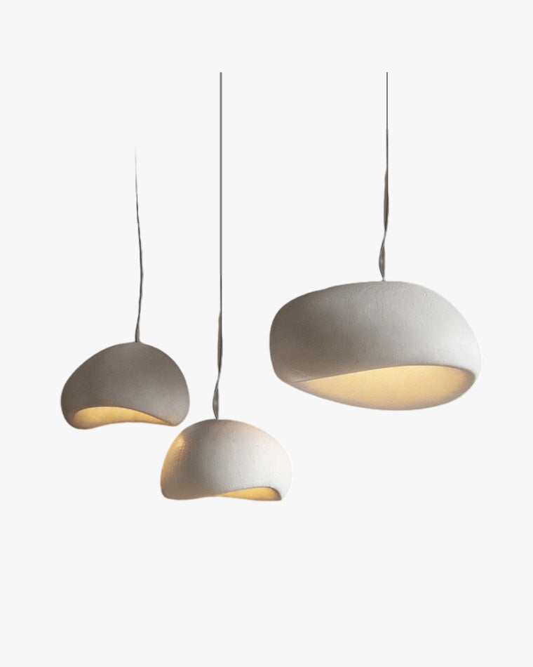 Three white sculptural pendant light fixtures with asymmetric resin dome shades on a clean background.