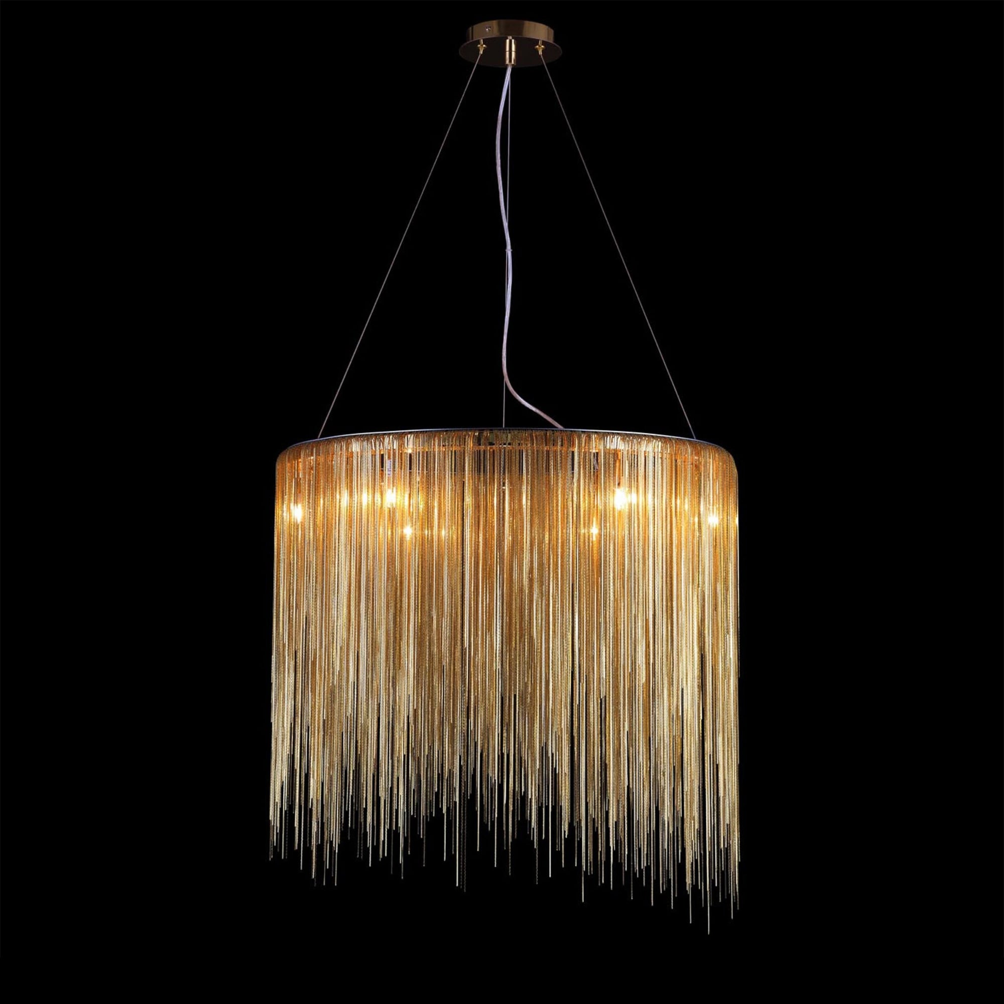 Gold 16-inch chandelier glowing against black, concentrating warm light into a compact jewel-like form with unmistakable quiet luxury.