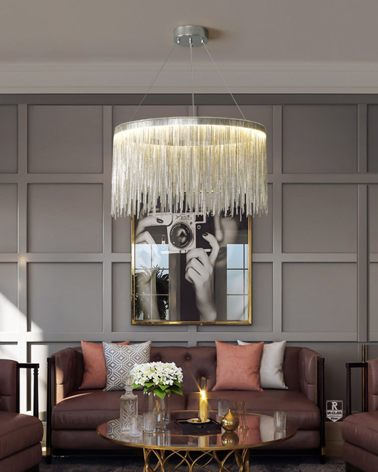 Silver fringe light above a mauve sofa and paneled wall, adding cool metallic contrast and an artful glow to the softly colored living room.