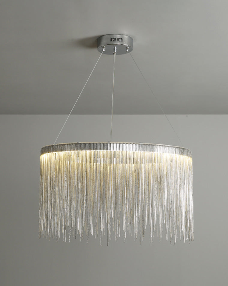 Illuminated silver waterfall chandelier displayed against a neutral background, revealing the soft halo and rippling shine created by its descending chains.