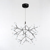 Black 45-light Firefly organic chandelier, creating depth through luminous leaves and sculptural branches instead of heavy ornamentation.