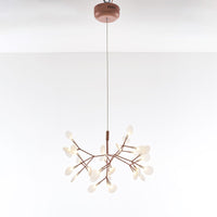 Illuminated 30-light rose-gold Firefly organic chandelier, creating a compact constellation for intimate living and dining areas.