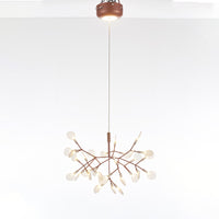 Rose-gold 30+1-light Firefly dining light fixture with an illuminated canopy, combining decorative firefly glow with additional functional light.
