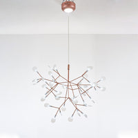 Rose-gold 45+1-light Firefly tree branch chandelier with canopy illumination, adding practical brightness beneath its sculptural branches.