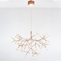 Rose-gold 63+1-light Firefly chandelier with an illuminated canopy, delivering the collection’s fullest silhouette and richest layered glow.