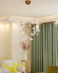 Airy Firefly living room chandelier complementing pale furnishings and green curtains with a graceful, naturally branching silhouette.