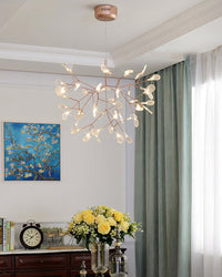 Rose-gold Firefly living room chandelier glowing beside soft curtains, bringing the wonder of floating fireflies into an elegant interior.