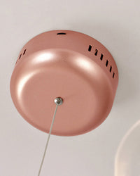 Close-up of the rose-gold ceiling canopy, showing the streamlined metallic finish that gives the Firefly chandelier a polished installation.