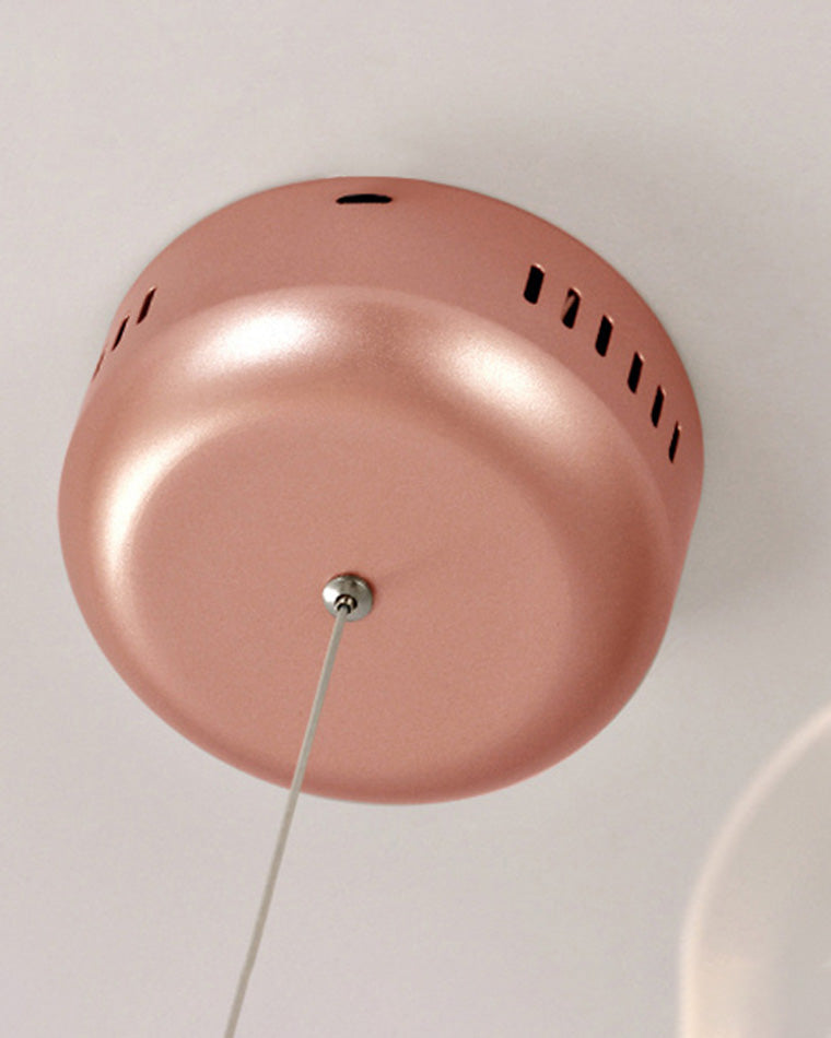 Close-up of the rose-gold ceiling canopy, showing the streamlined metallic finish that gives the Firefly chandelier a polished installation.