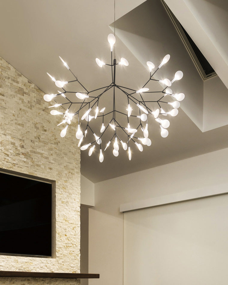 Radiant Firefly tree branch chandelier viewed from below, filling an angled ceiling with scattered points of light without visual heaviness.