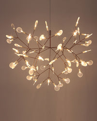 Illuminated rose-gold Firefly organic chandelier seen from below, revealing a layered constellation of branches and softly diffused leaves.