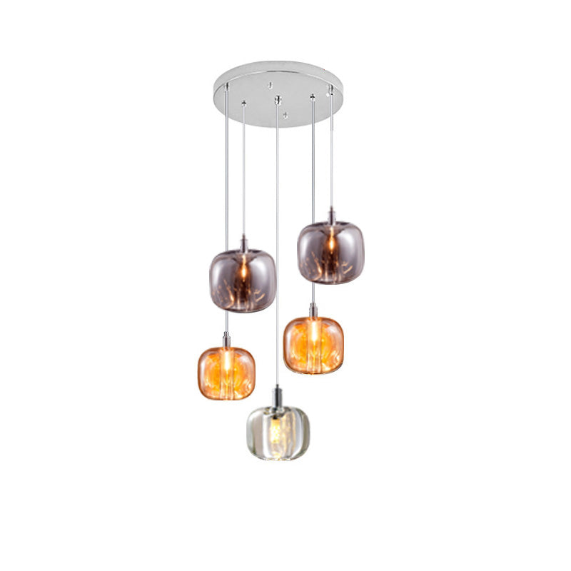 Five-light glass chandelier with amber, smoked, and clear shades in a compact tiered drop for foyers, stair corners, or dining nooks.