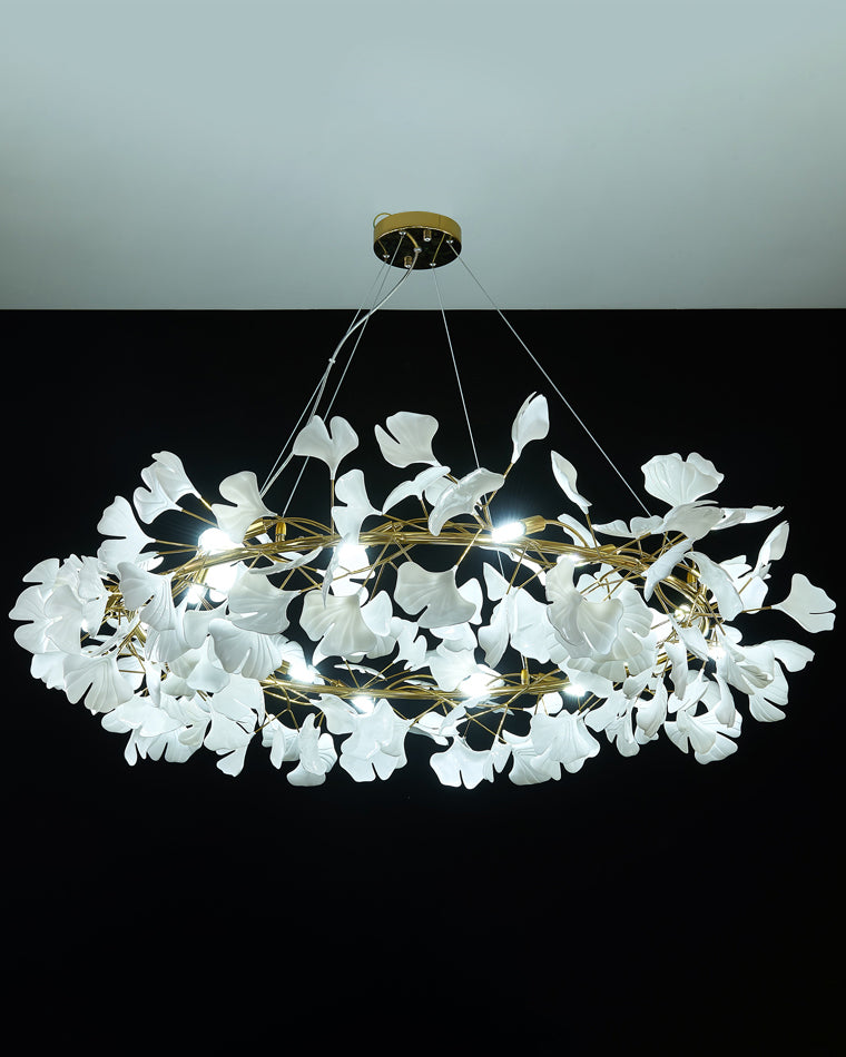 Gold-framed WM2414 chandelier glowing in cool white light on black.