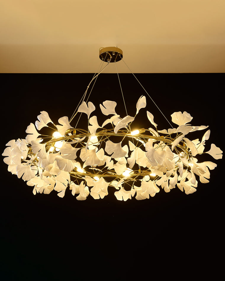 Gold-framed WM2414 chandelier glowing in warm white light on black.