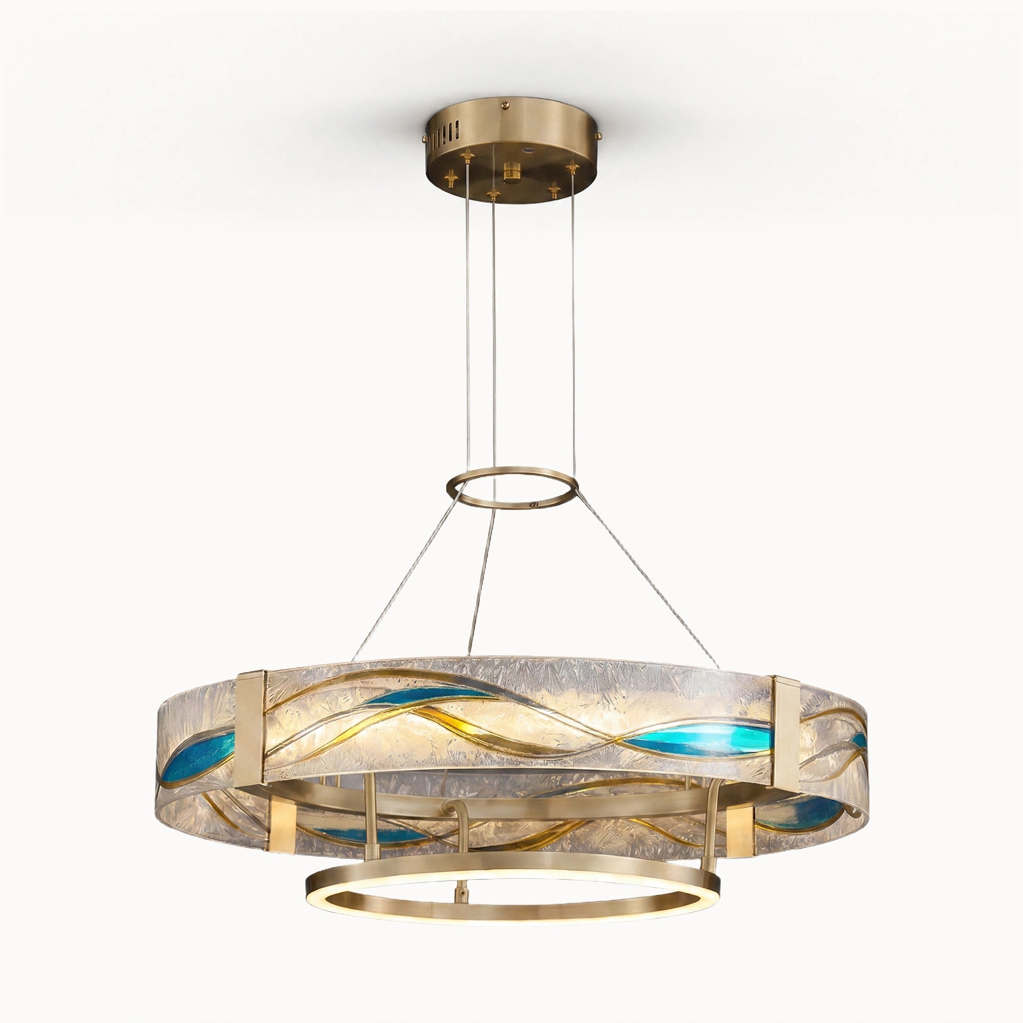 Enamel round brass chandelier in gold with textured glass, blue enamel wave inlays, slim suspension cables, and a glowing lower LED ring on a white background.