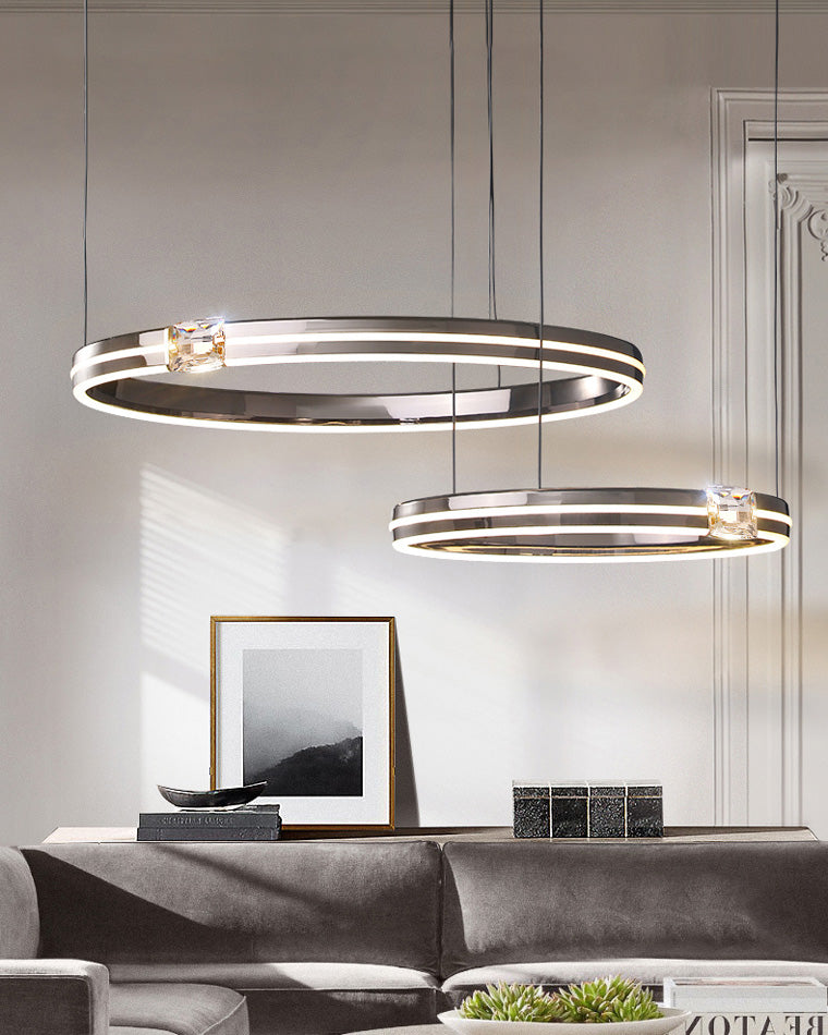 Double-ring modern chandelier above a contemporary sofa, adding structure and soft illumination without crowding the living room.